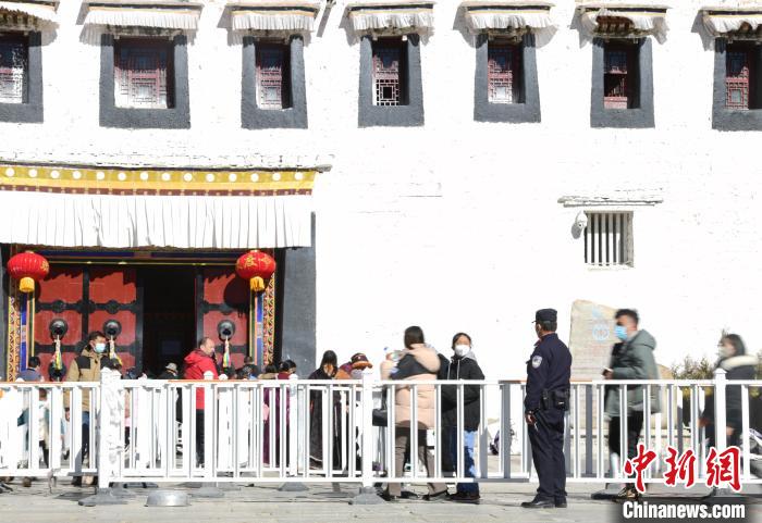 圖為1月23日，布達拉宮廣場派出所民警正在引導游客?！∝暩聛硭?攝